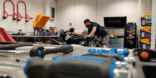 mechanic working on an electric motorcycle at go green motorcycles london